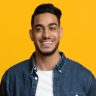 smiling-middle-eastern-man-in-casual-with-laptop-Y9EY47V.jpg